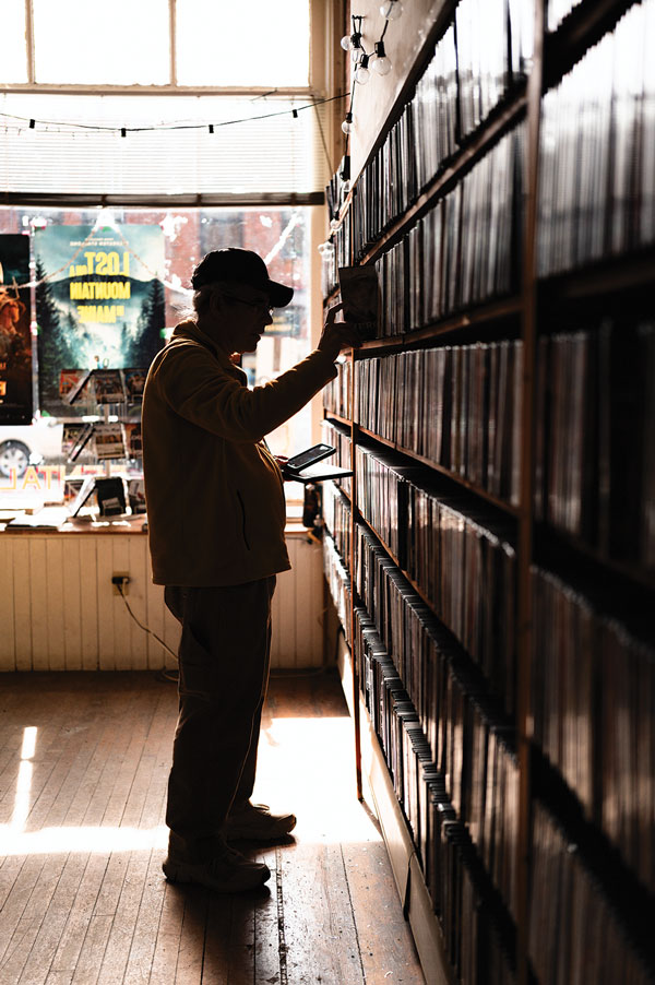 customer browsing Opera House Video's shelves for movies
