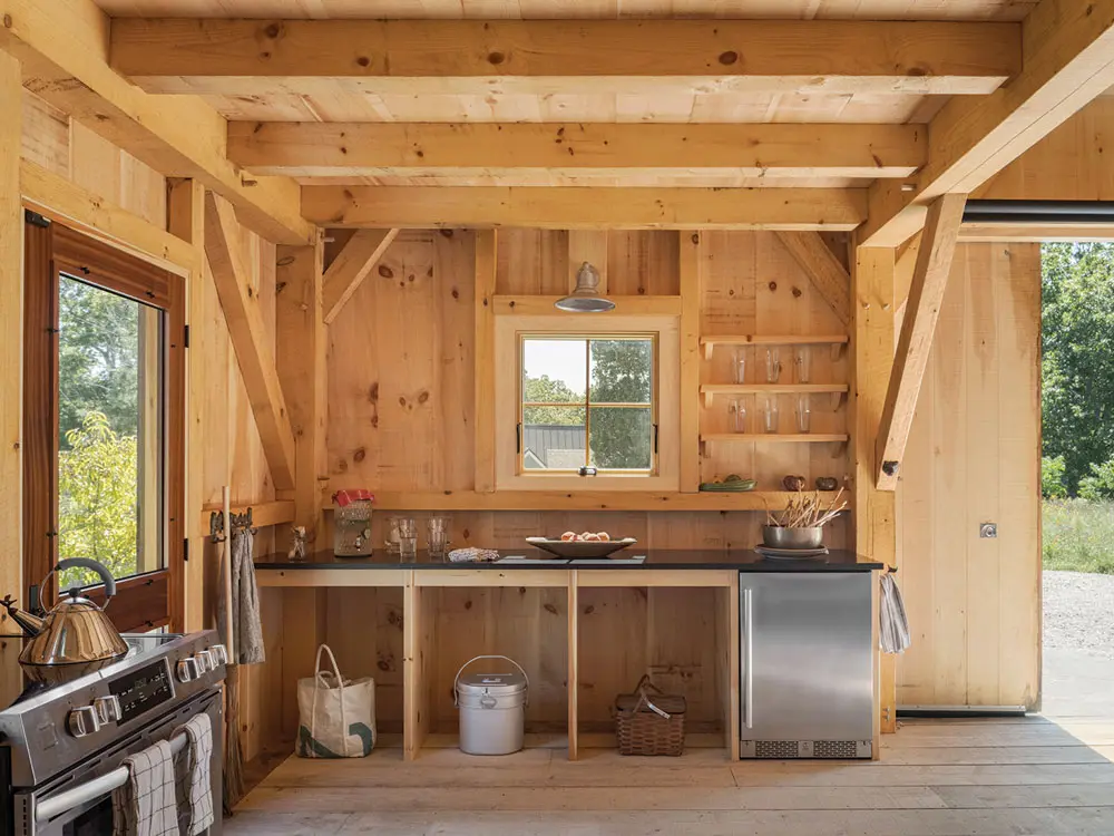 the timber-frame barn is equipped with a kitchen to facilitate entertaining