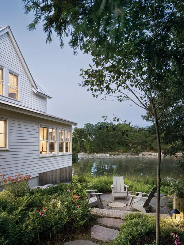 armouth landscape designer Kathleen Fitzgerald, of Tide Walk Designs, and North Yarmouth installer Samuel Knight feathered a rounded granite patio