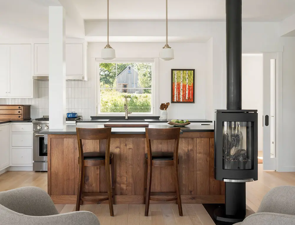 kitchen cabinetry was crafted out of some of the same salvaged walnut used in the dining area